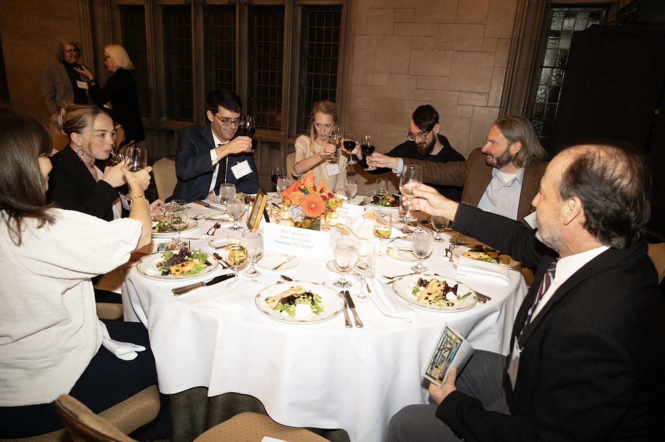 A group of attendees cheers their glasses at Conversations Before Midnight 2024.